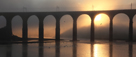 Royal Border Bridge, Berwick-Upon-Tweed with shafts of evening sunlight through mist (sea fret)