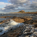 Bamburgh Castle and waves from Harkess Rocks